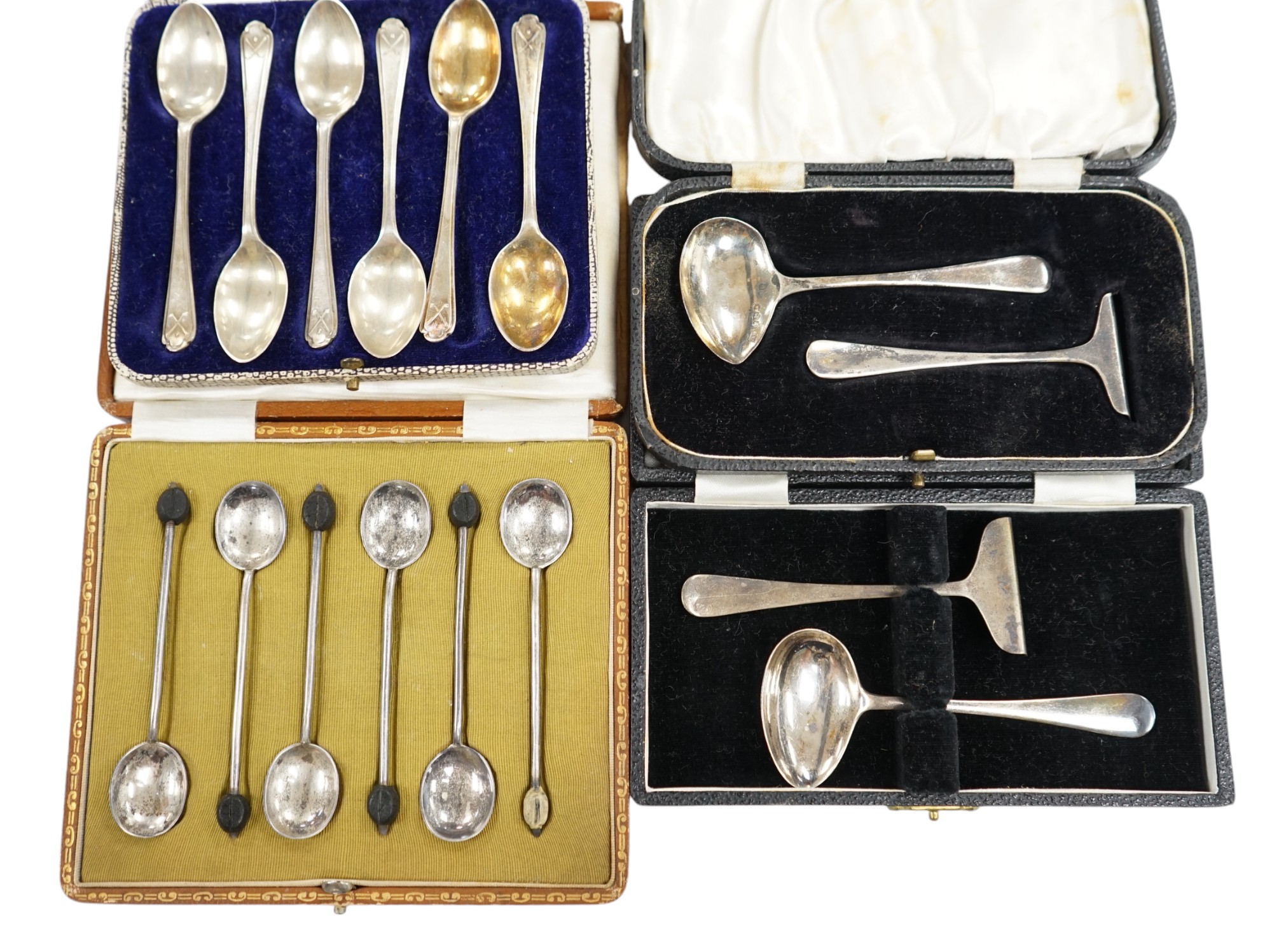 Two cased sets of six silver coffee spoons including bean end and golfing related and two cased silver christening spoons and pushers. Condition - poor to fair